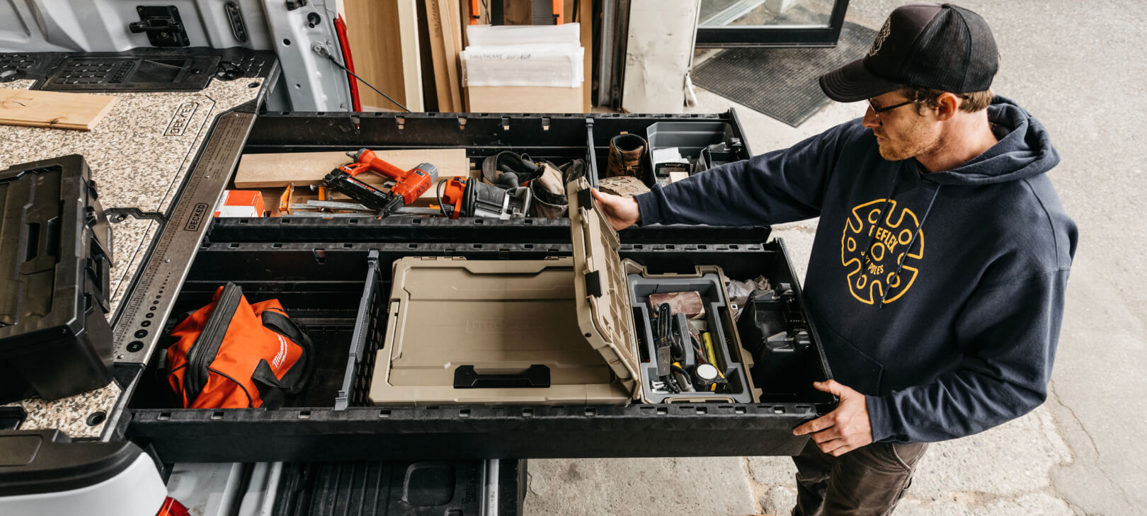 Overhead view of a man opening a Sixer inside a Full-Size Drawer System.