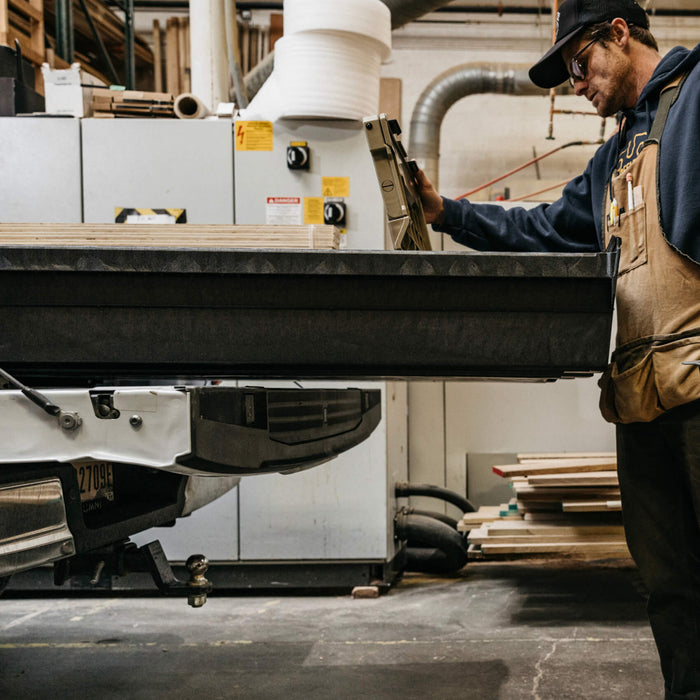 man reaching into a drawer system when it's fully extended