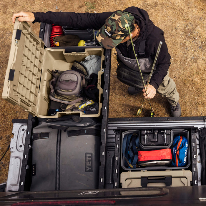 man opening a halfrack in a drawer system holding fishing rods