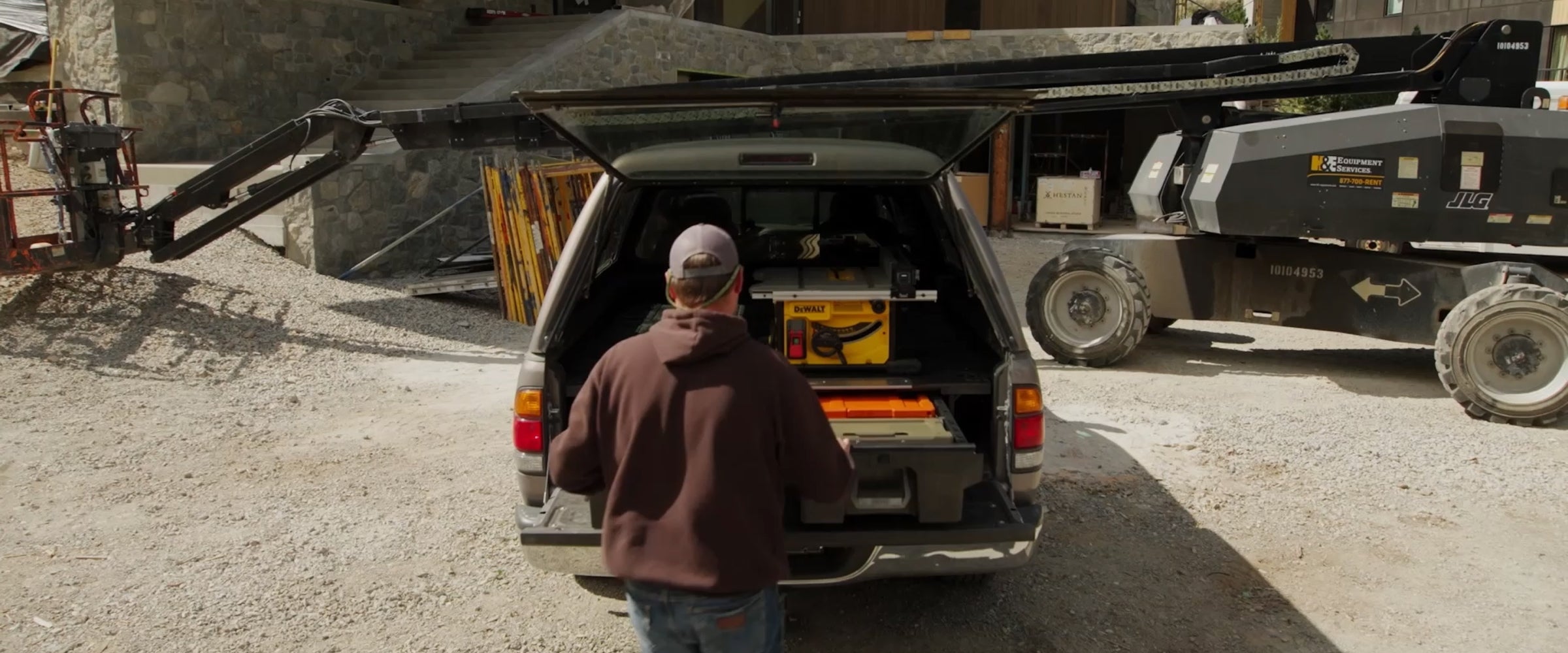 Person loading equipment into a truck in an industrial setting