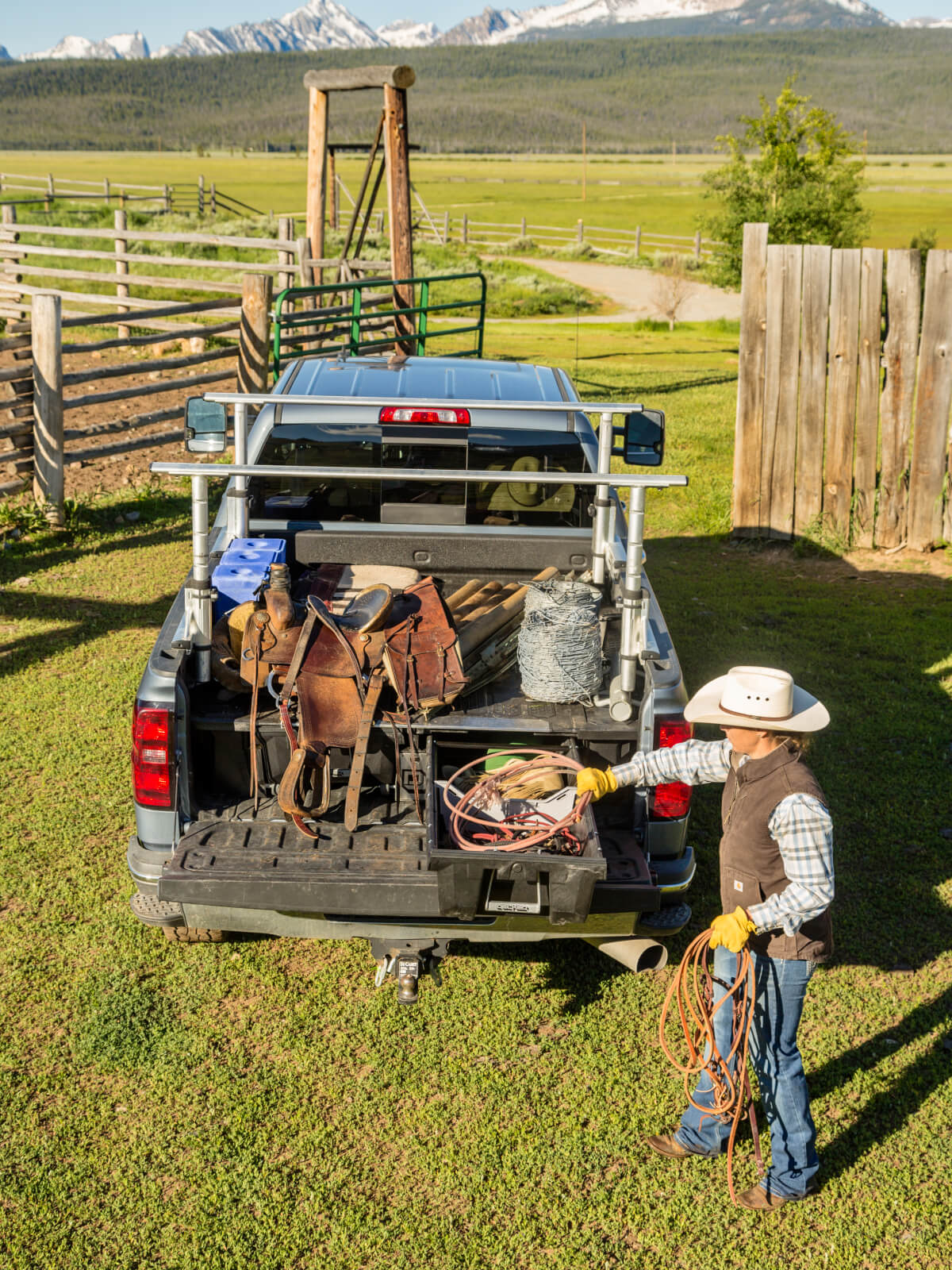 Man accessing his farm tools in a drawer system in the back of a truck