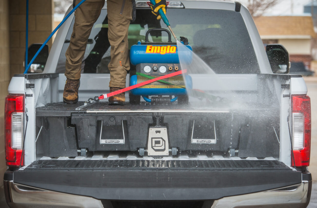 spraying decked drawer system with a power washer