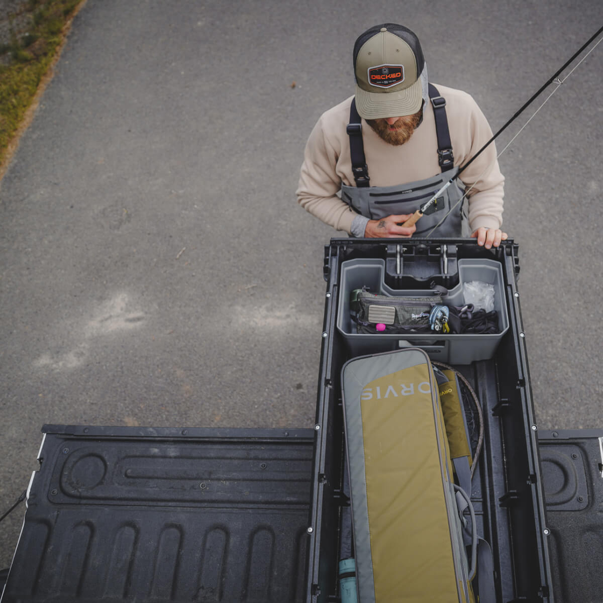 person accessing their decked drawer system to grab their fly fishing rod