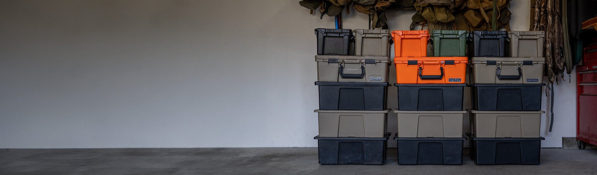 DECKED D-CO cases stacked in a garage.