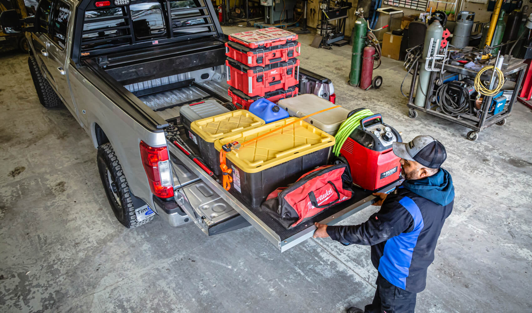 man pulling out a cargoglide loaded down with tools in his shop