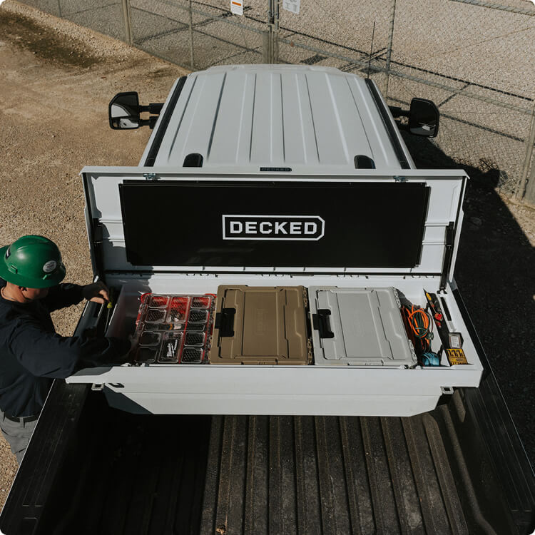 Person organizing tools in a DECKED Tool Box organizer.