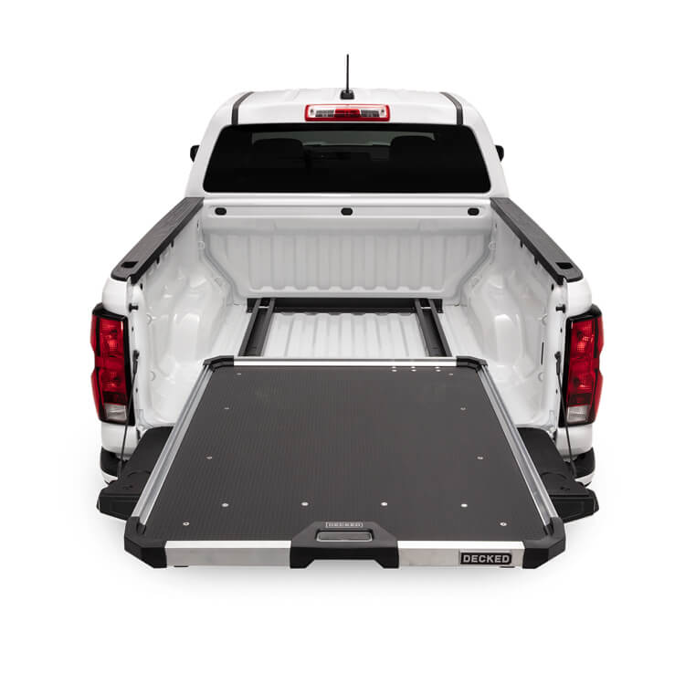 White truck with a black DECKED CargoGlide bed extension on a white background