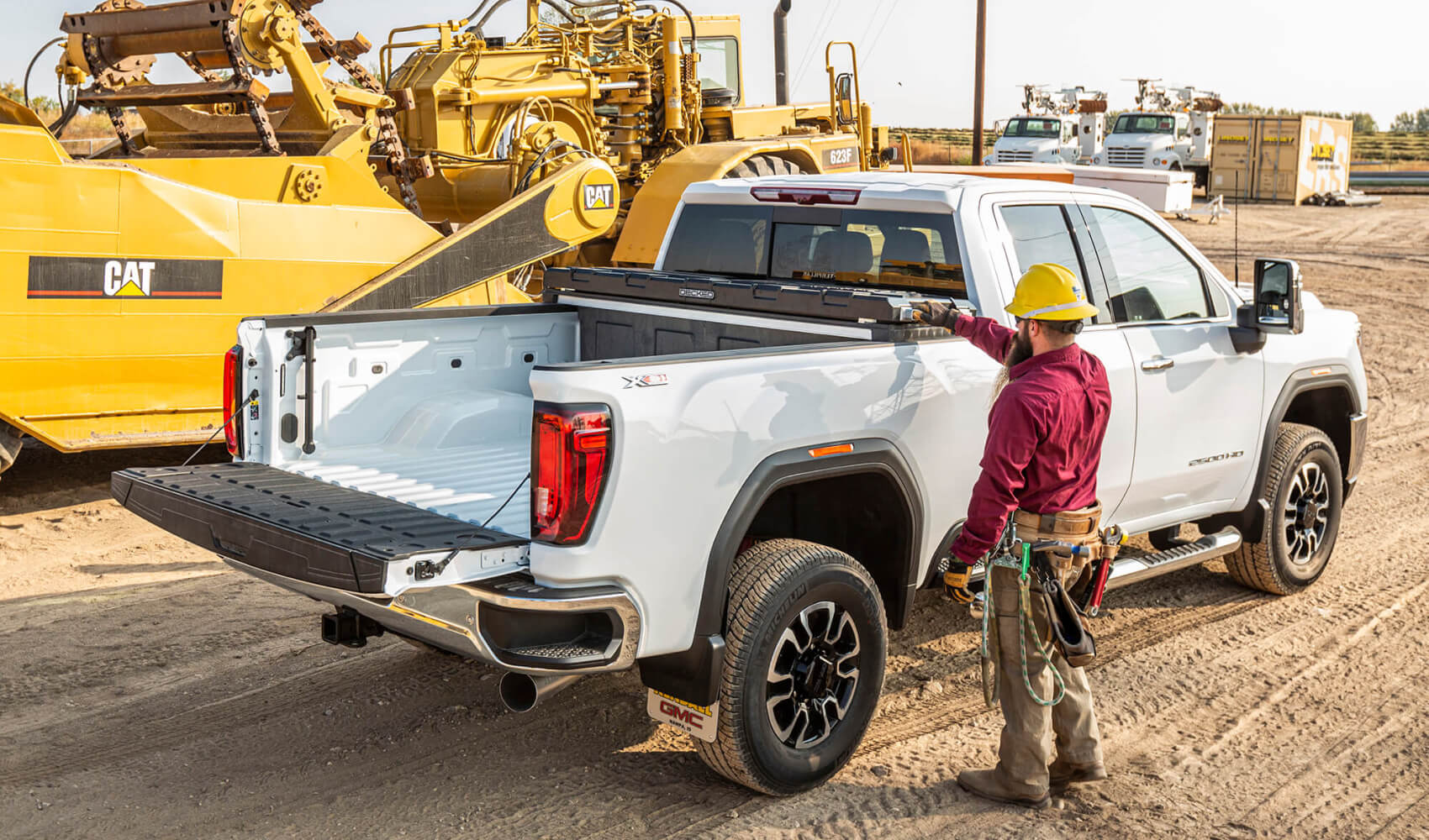 Construction worker accessing his decked tool box in the back of his truck