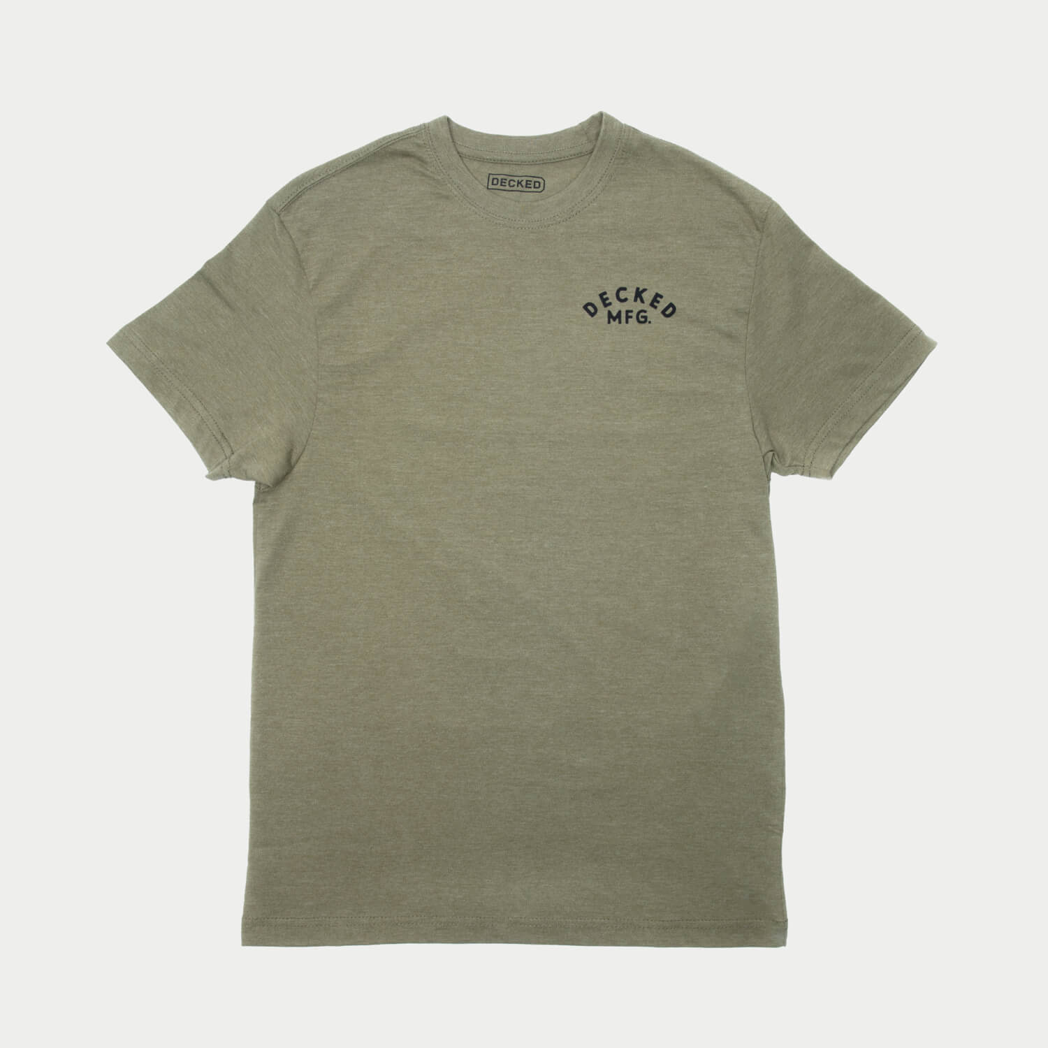The front of a green t-shirt with a small logo that says DECKED MFG. the shirt is on a light gray background