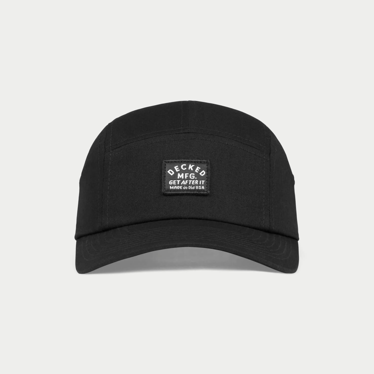 A black 5-panel hat that has a small DECKED patch that says GET AFTER IT and Made in the USA.