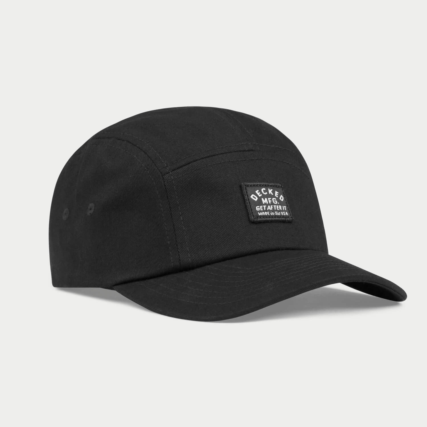An angled black 5-panel hat that has a small DECKED patch that says GET AFTER IT and Made in the USA.