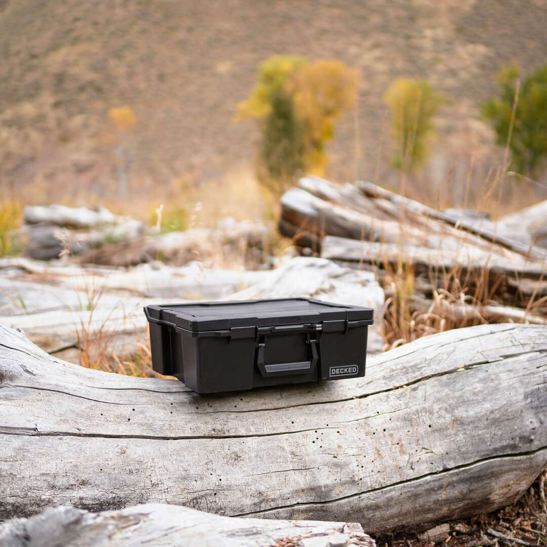 Black Halfrack 32 in the backcountry sitting on a log.