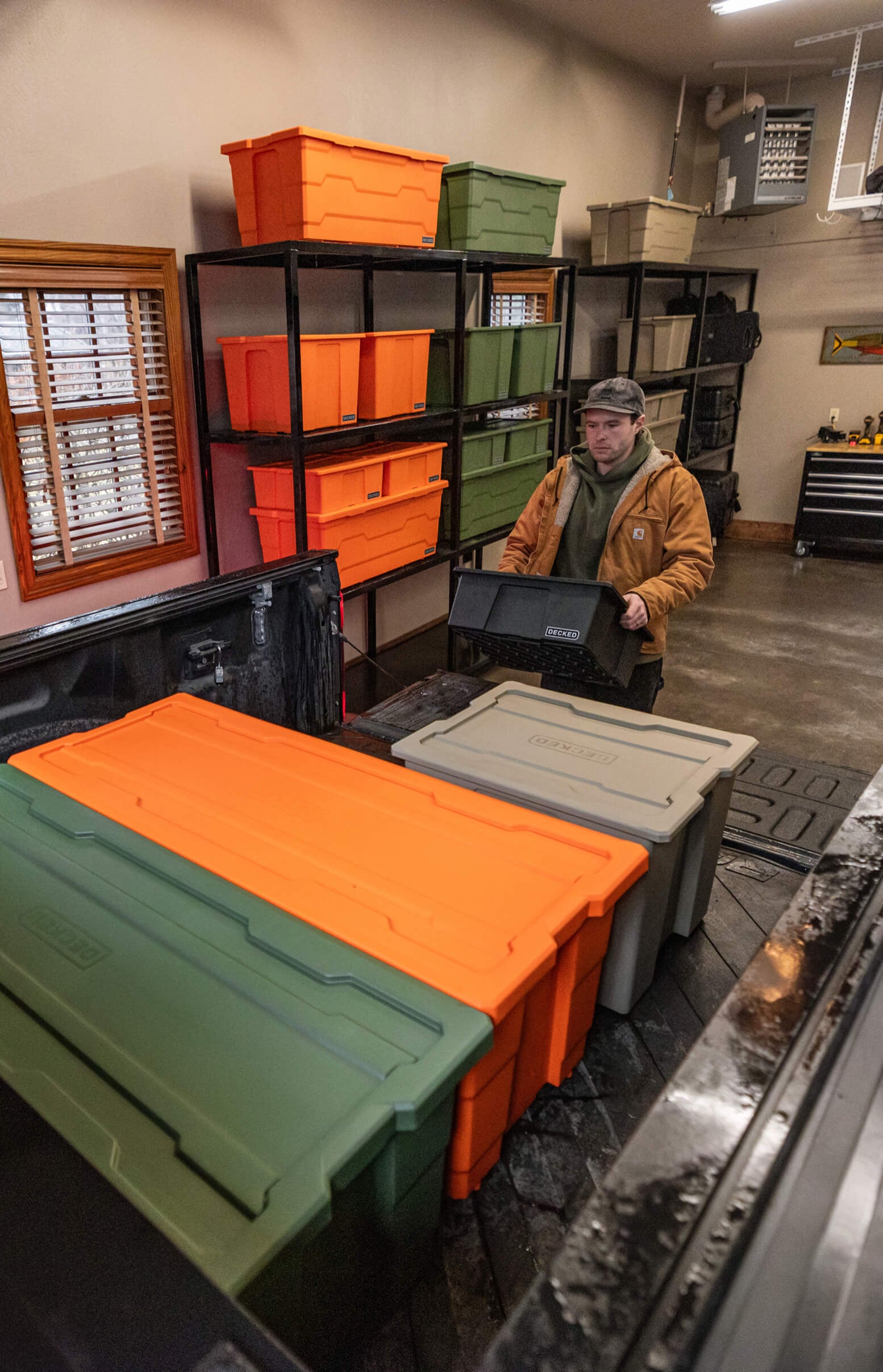 Person in a workshop with Payloader storage bins and shelves.