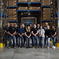 Decked employees standing in front of a warehouse of packaged Decked Systems in Defiance, Ohio.