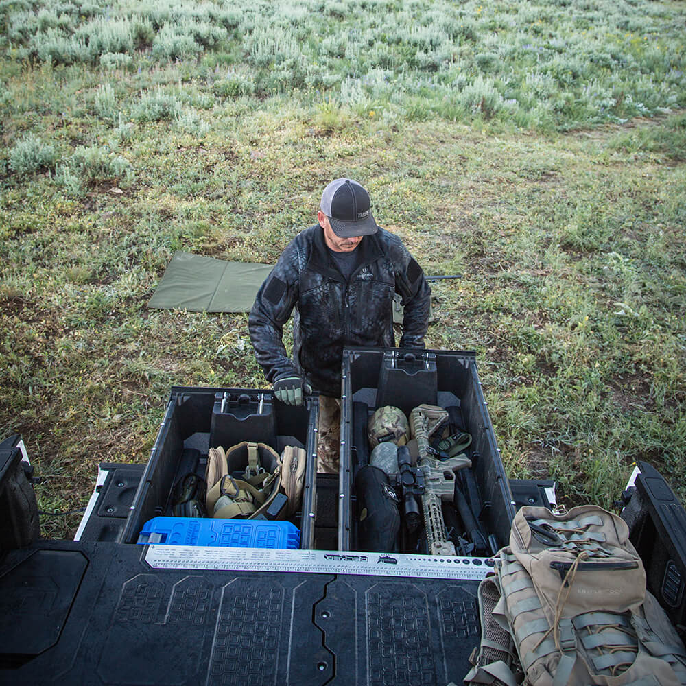 Man grabbing his weapon out of his decked drawer system