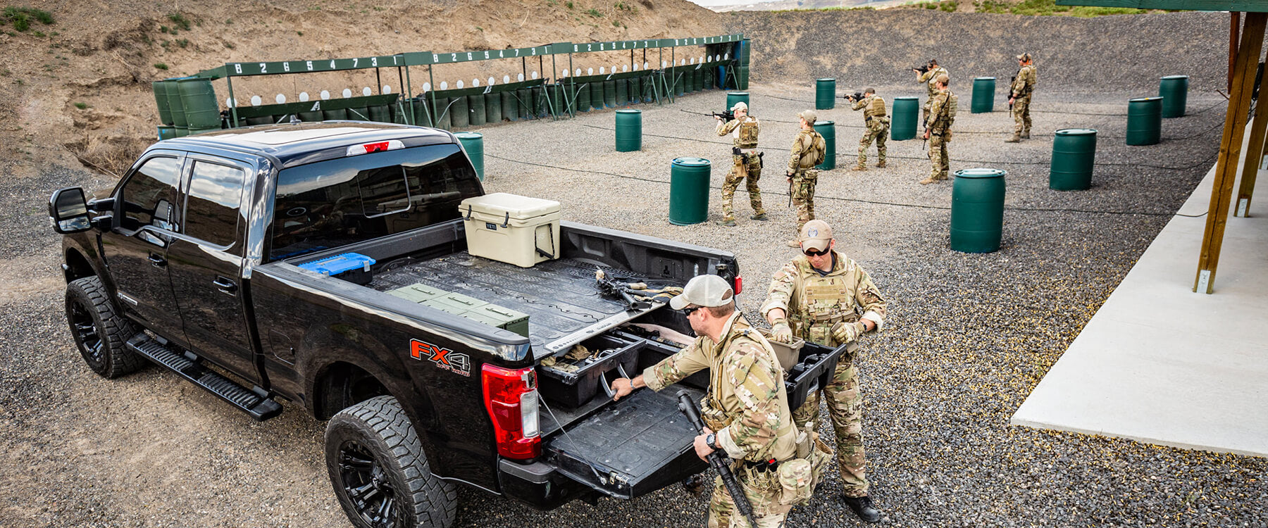 Soldiers reaching inside their decked drawer system at the shooting range