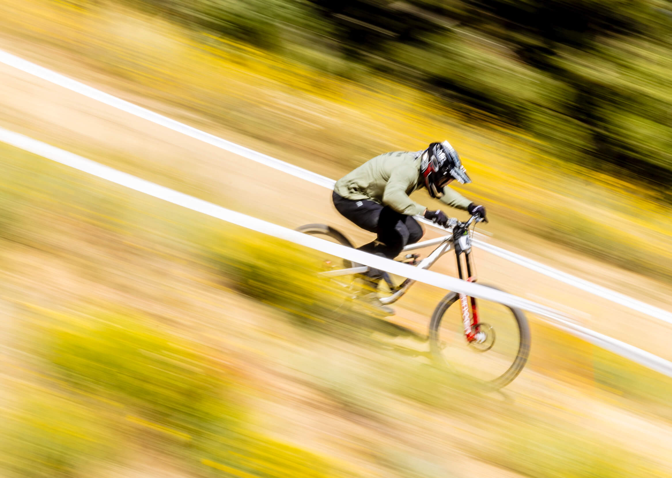 Kyle Strait during a mountain bike race, speeding downhill.