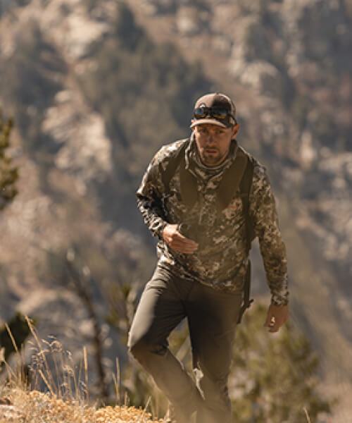 Man hiking in hunting clothing