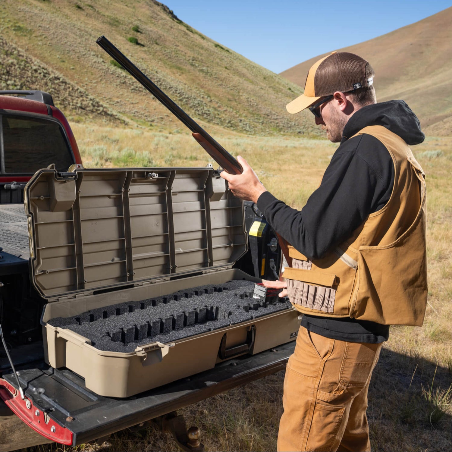 A bird hunter reassembling his shotgun that he stores in his Mossy Oak Honcho storage case.