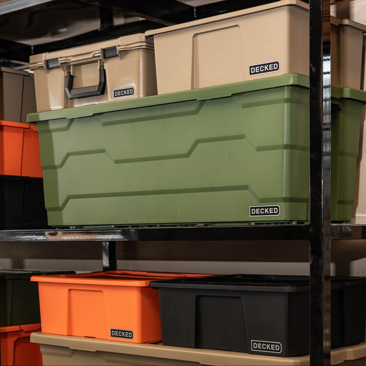 Stack of Payloader storage bins in various colors on a shelf with 'DECKED' branding.