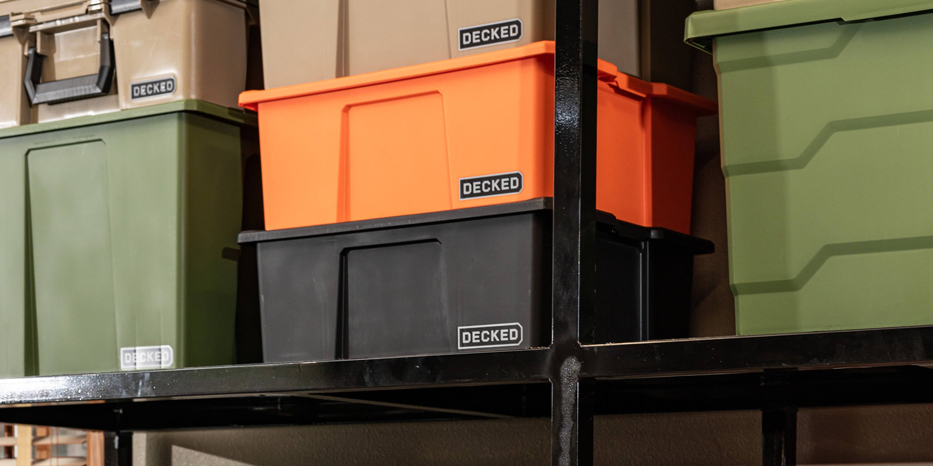 Stack of Payloader bins in various colors with 'DECKED' branding on a metal shelf.