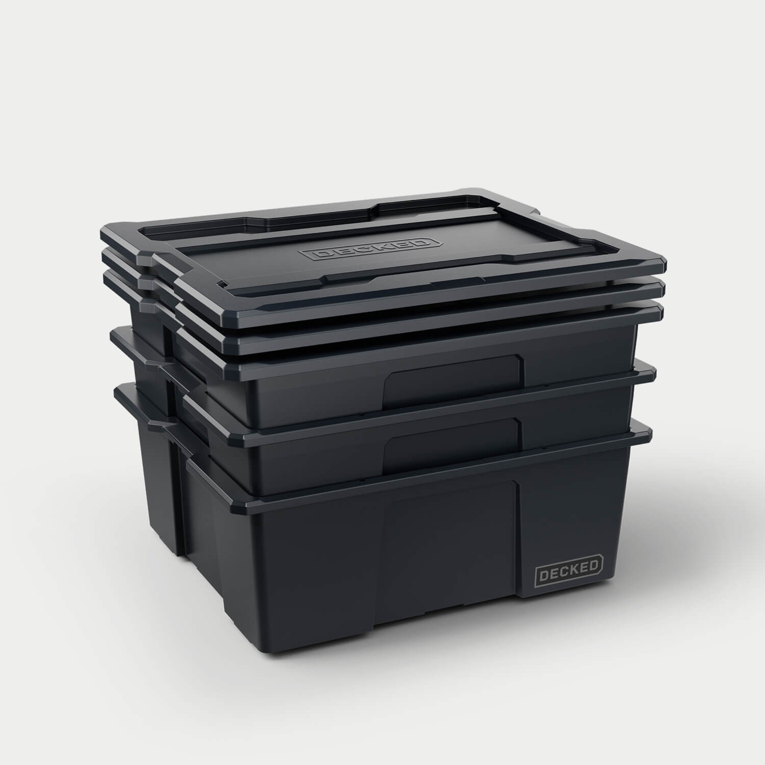 Three black Payloader bins nested together with the three lids stacked on top.