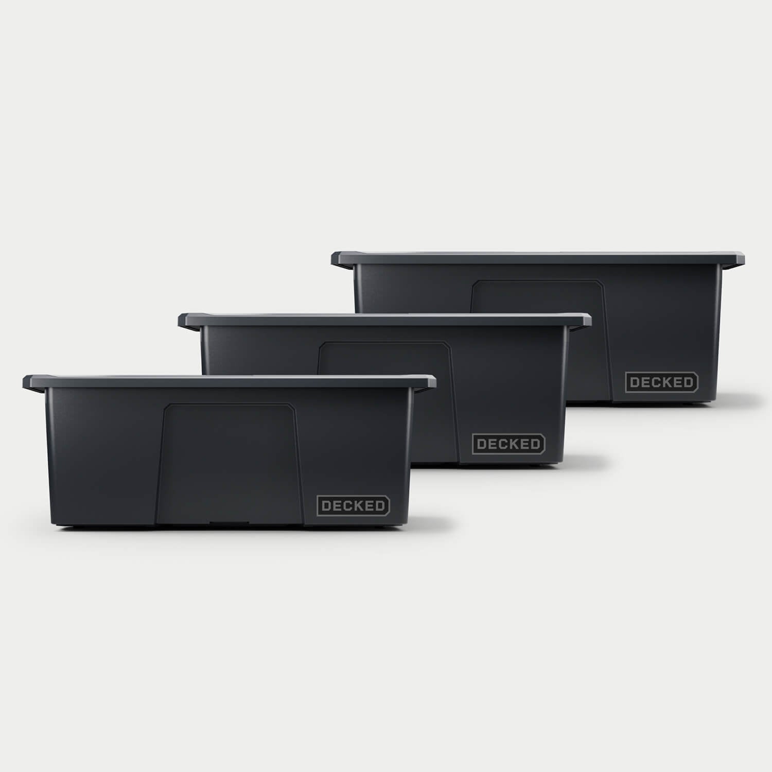 Three black Payloader bins, closed on a white background, staggered diagonally.