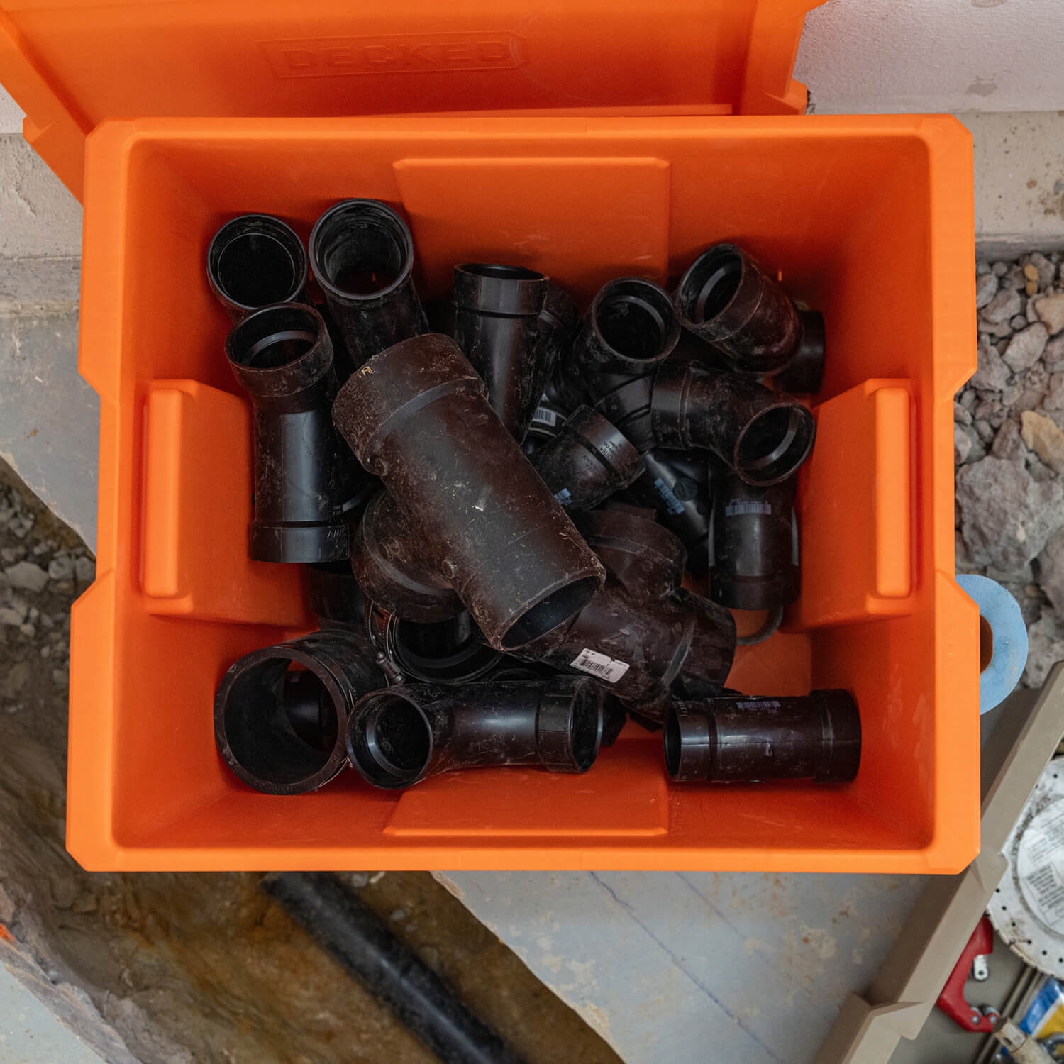 Small pieces of pipe inside of a DECKED Payloader Bin.