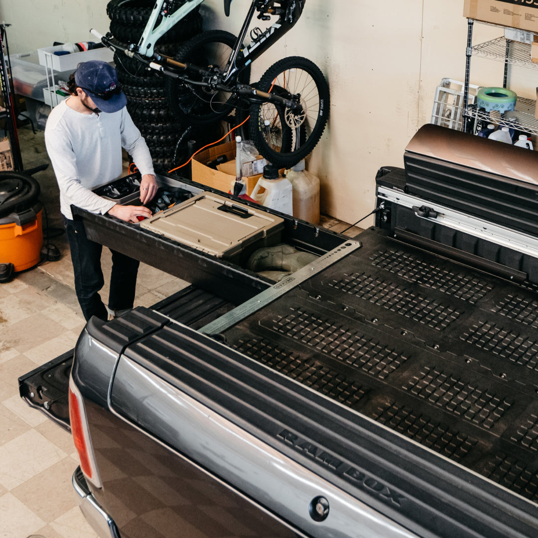A man in his garage workshop retrieving gear from his Rambox Drawer System.