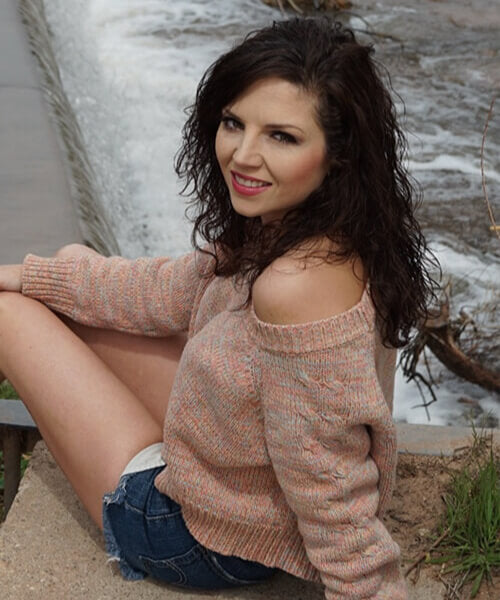 Woman posing next to a river