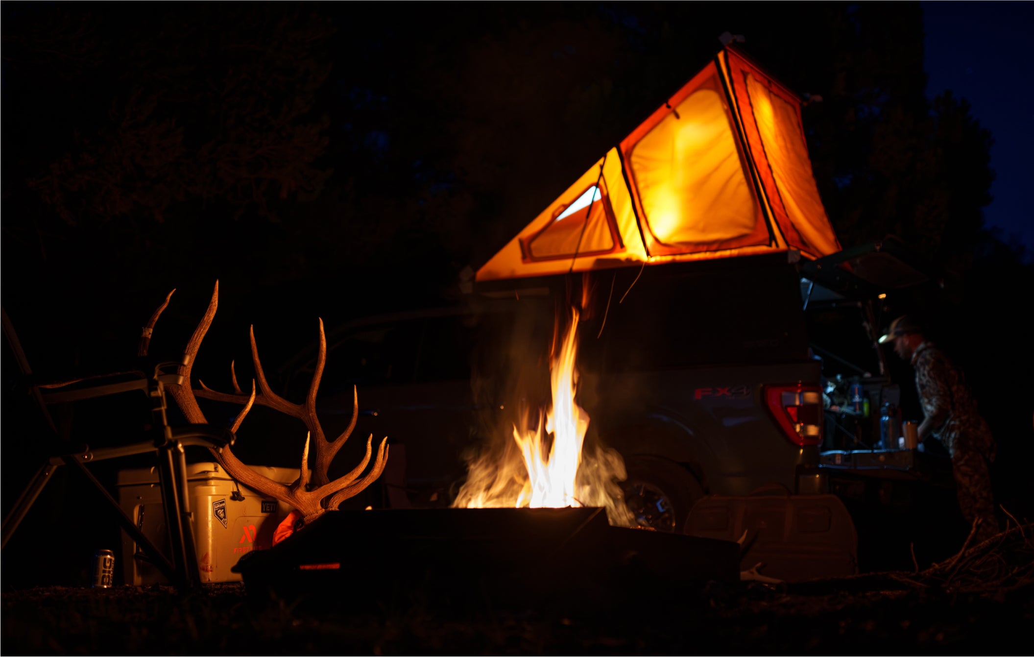 Remi Warren's hunt basecamp with his truck equipped with a DECKED Drawer System and rooftop camper.