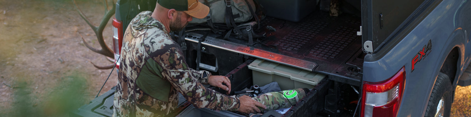 Remi Warren grabbing his elk bugle tube out of his DECKED Drawer System before heading out to hunt.