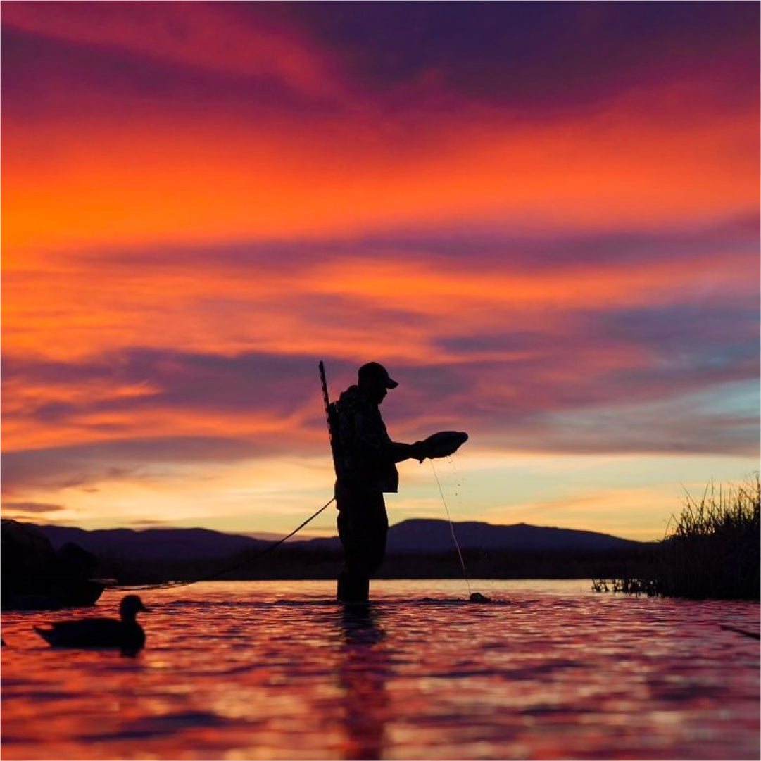 Remi Warren pulling up his duck decoys at sunset.