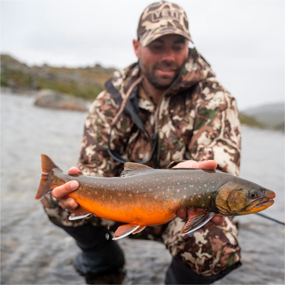 Remi Warren holding up a beautiful fish caught on the fly.