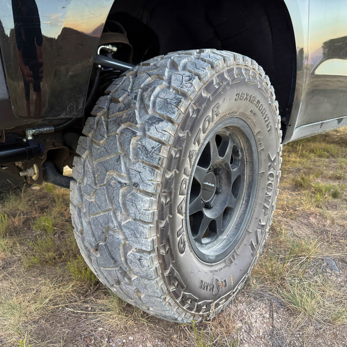 Tire with 'Gladiator' branding on a vehicle in an outdoor setting
