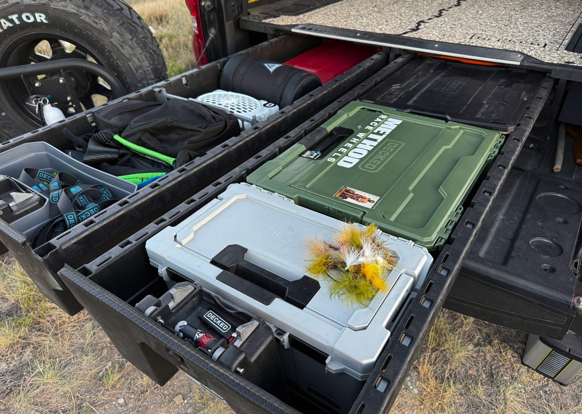 Open truck bed with storage compartments and tools on a natural background