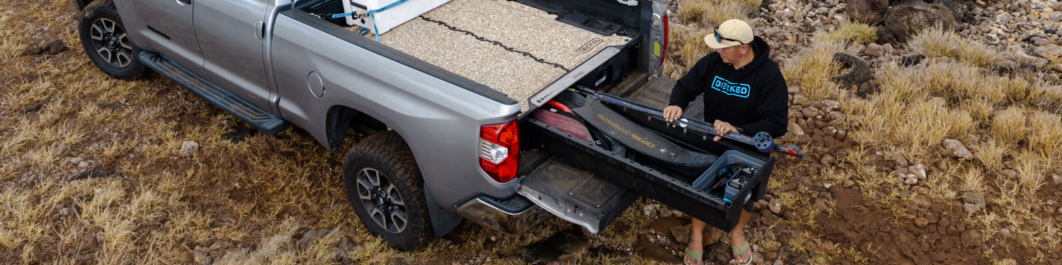 Justin Lee in his DECKED Gear pulling his speargun out of his DECKED Drawer System in Hawaii.
