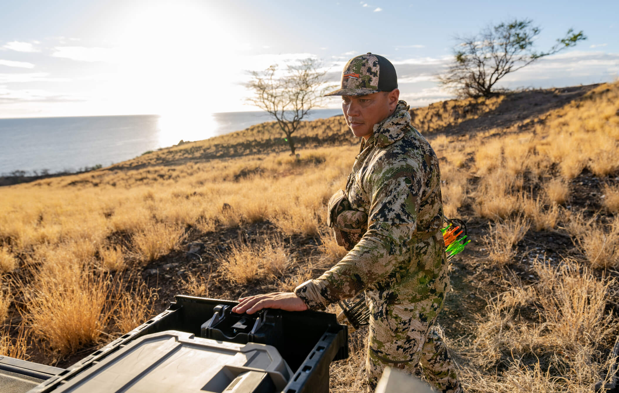 Justin Lee in camp pulling his bow out of his DECKED Drawer System.