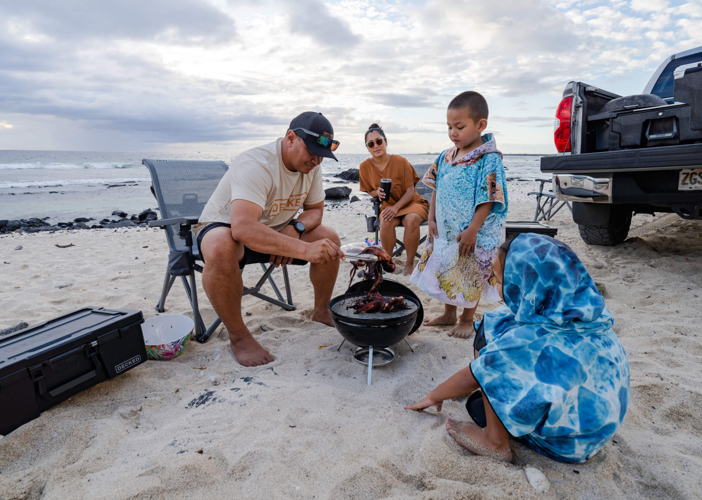 Justin Lee grilling up some grub for his wife and kids on the beach.