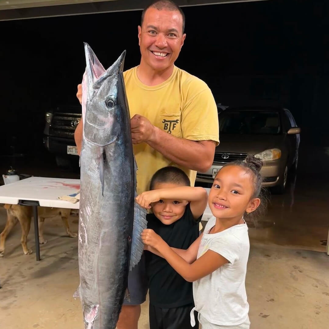 Justin Lee and his kids with his daily catch, that is taller than either of his kids.