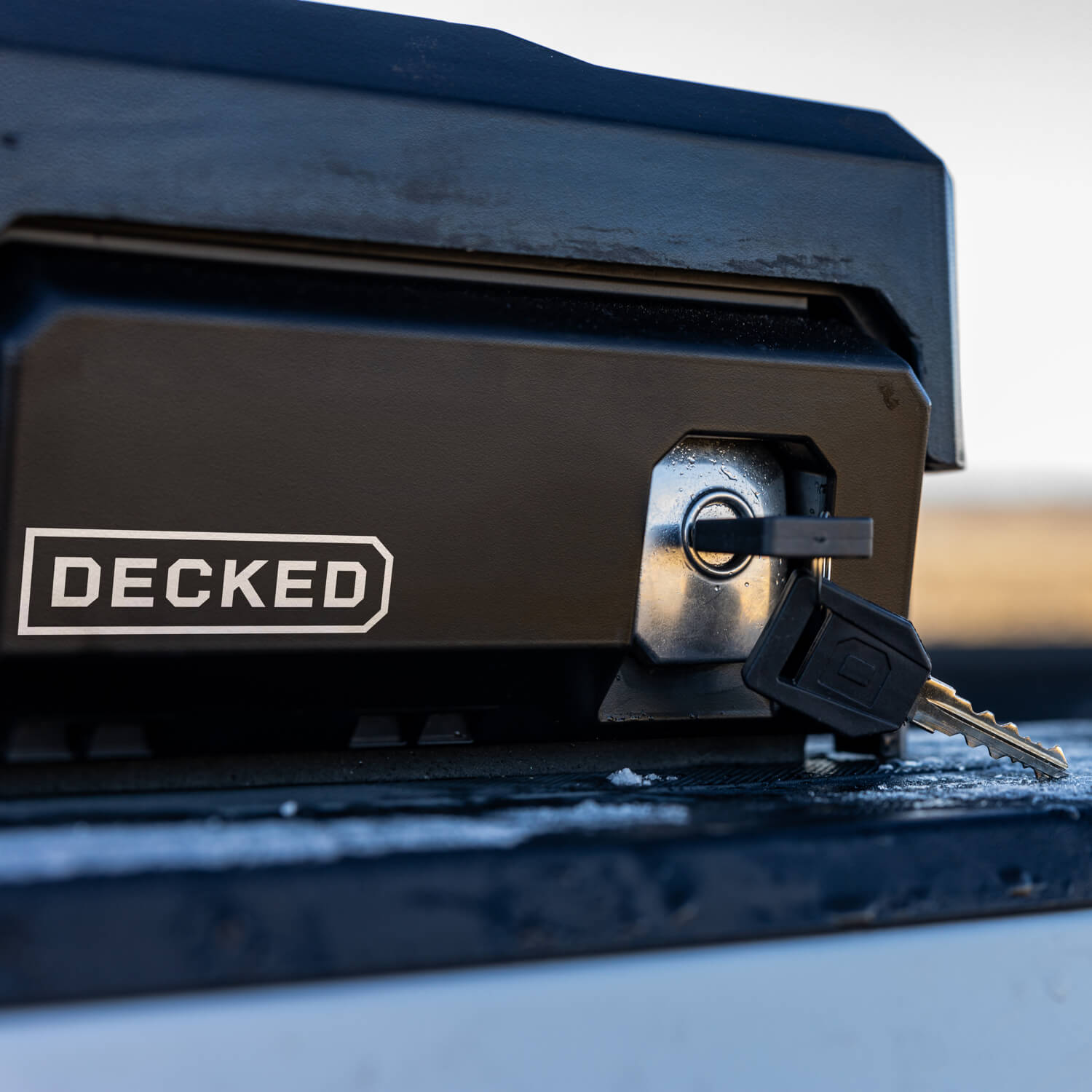 Key inserted into the DECKED Tool Box lock on the driver side of a truck bed.