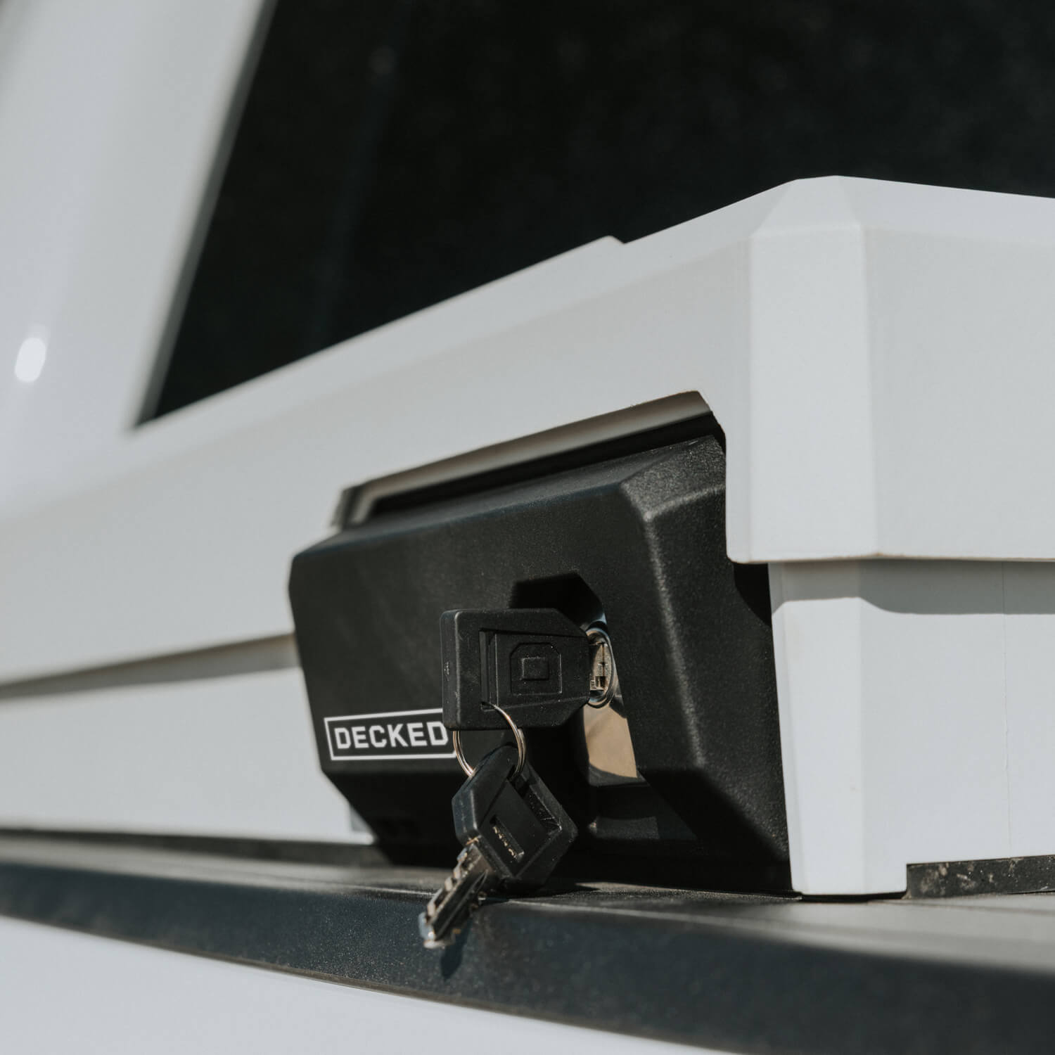 Close-up of a key inserted into a vehicle's DECKED Tool Box lock.