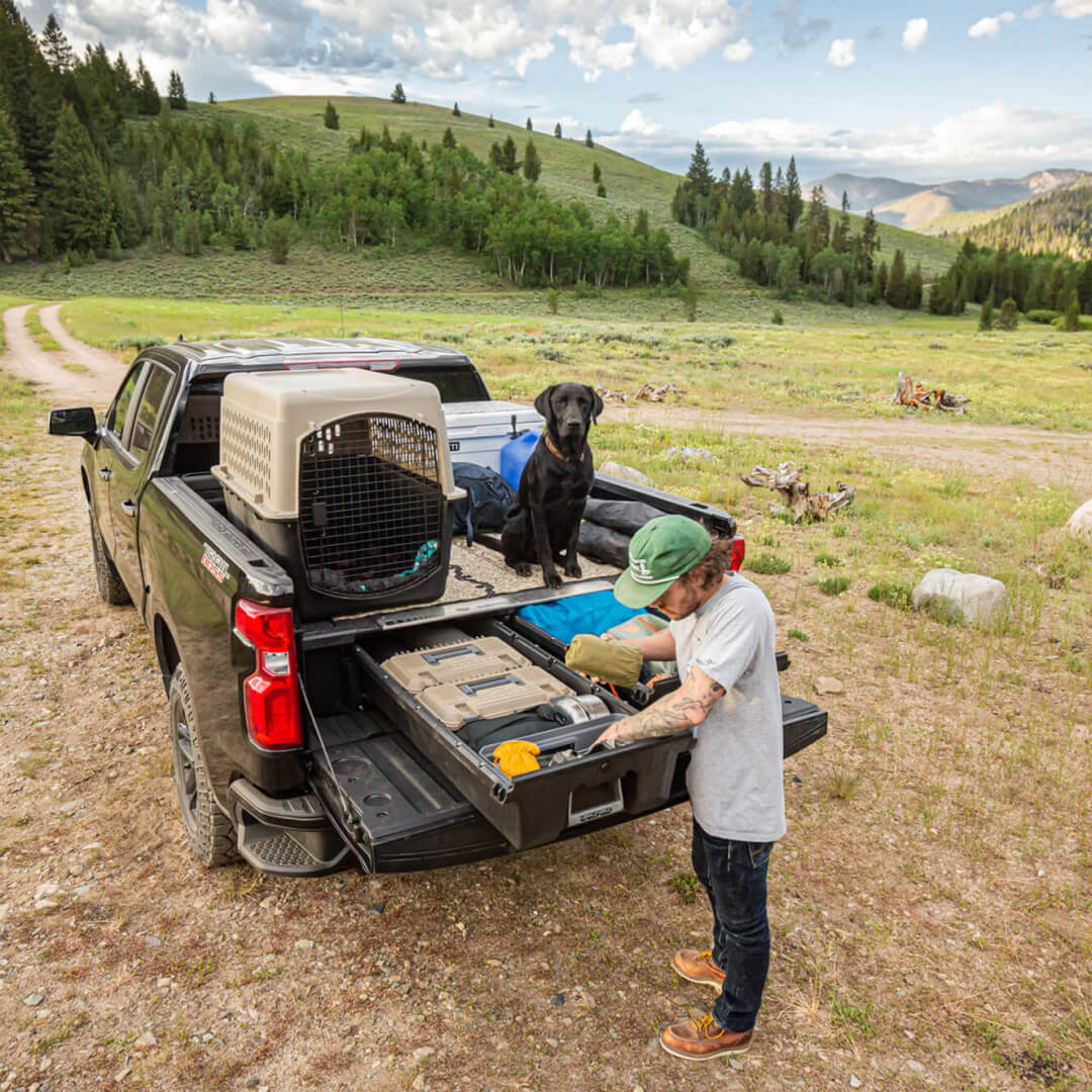 Man grabbing camping gear out of his Drawer System while camping in the mountains