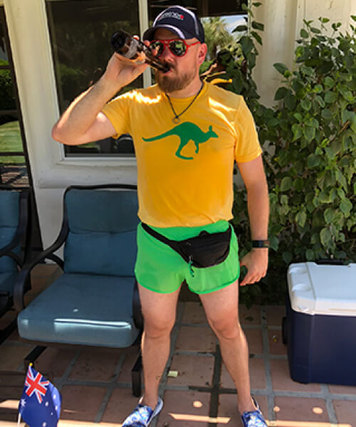Man wearing shorts drinking a beer