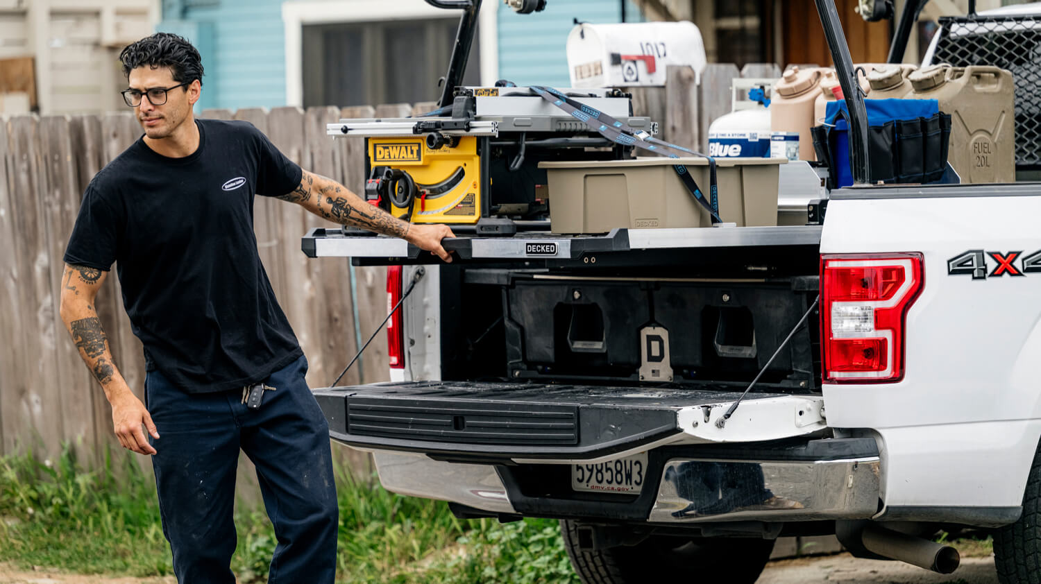 A worker sliding out a CargoGlide mounted on top of a DECKED Drawer System.