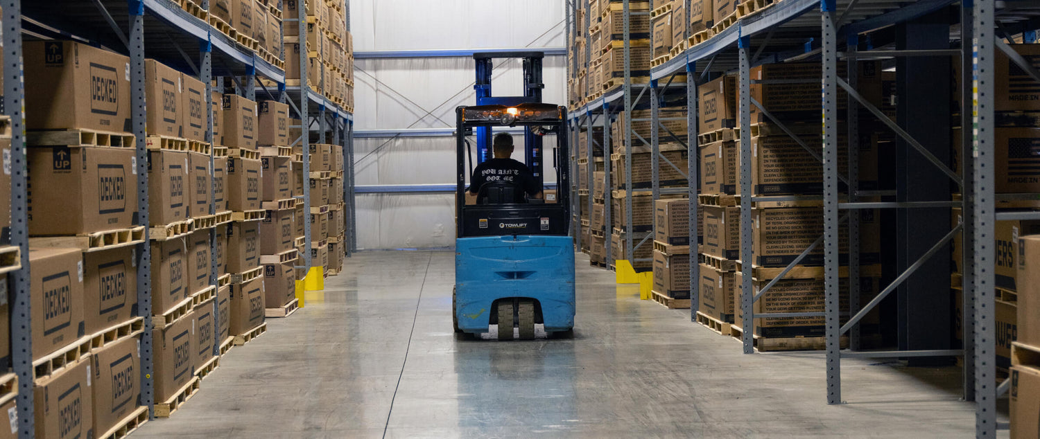 Forklift in a warehouse with stacked DECKED Drawer System boxes