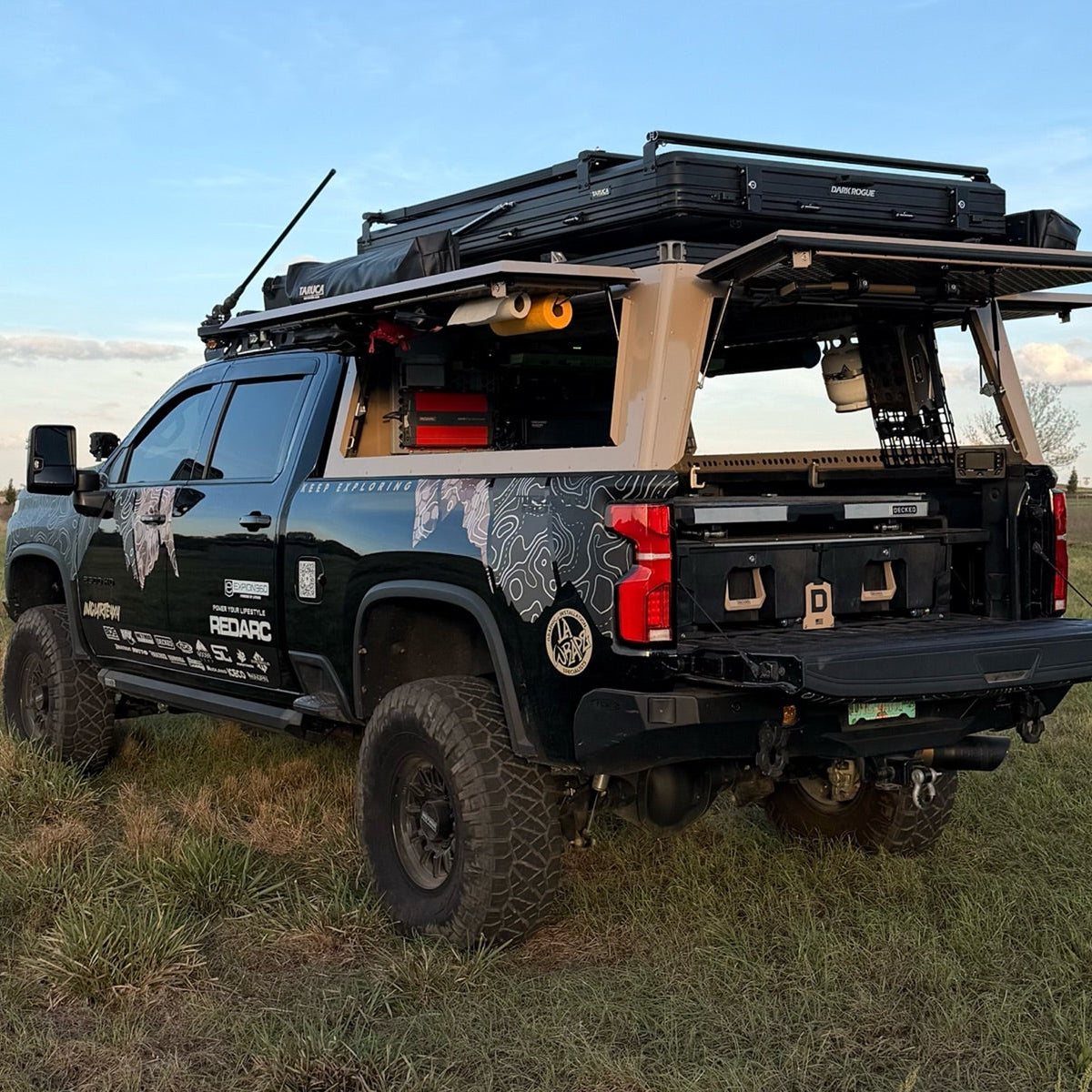 Black truck built out with overlanding gear and a black DECKED drawer system.