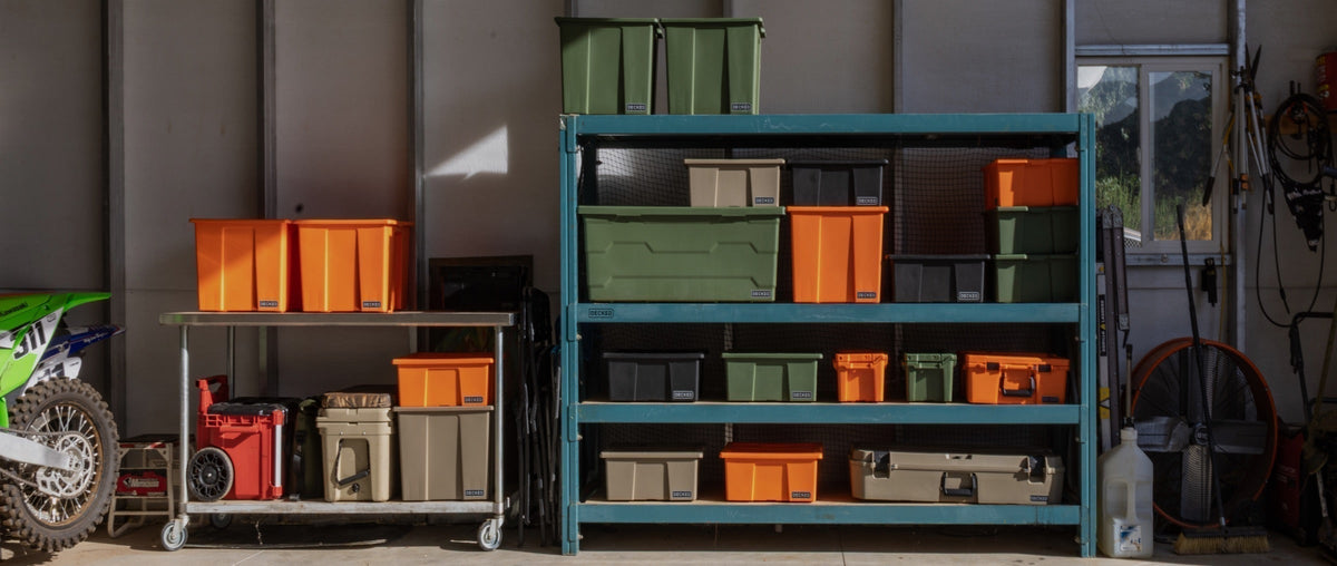 DECKED Cases and bins of different sizes and colors organized in a garage shelving unit.