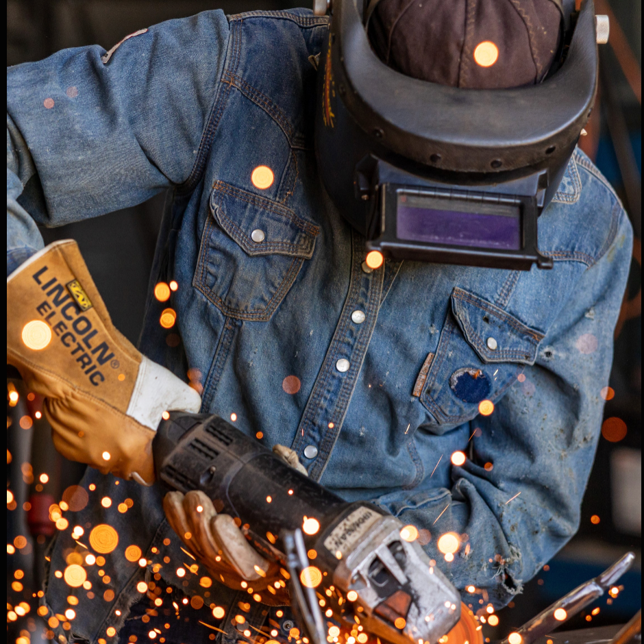 Image of man of tradesman using steel cutter.