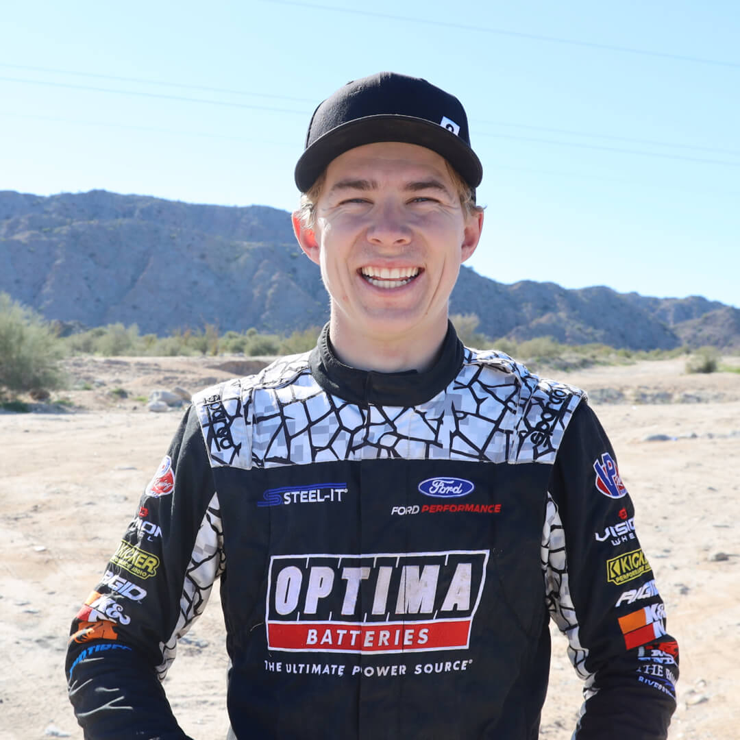 Chris Polvoorde smiling in his racing gear.